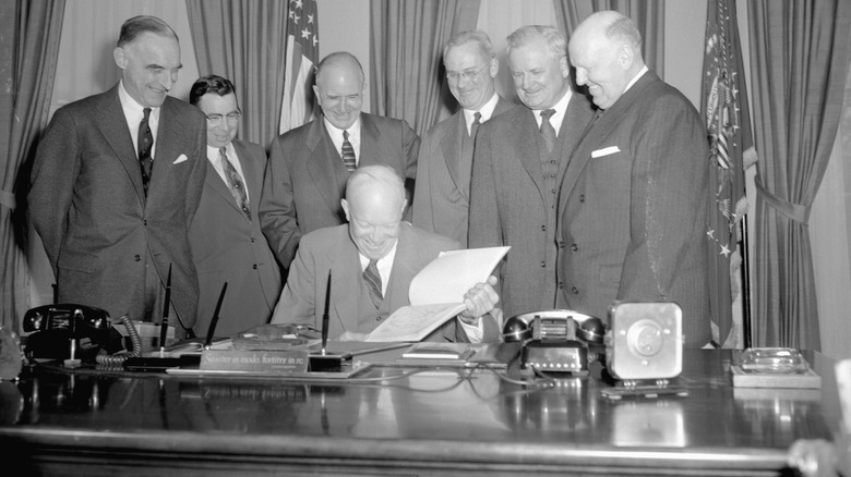 Members of the president's advisory committee on national highways are shown as they presented President Eisenhower with its recommendations.