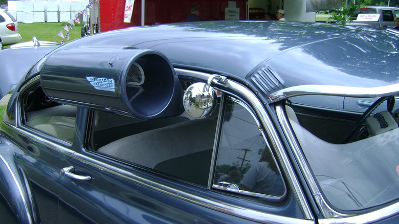 A vintage Thermador Car Cooler attached to a Volkswagen's side window