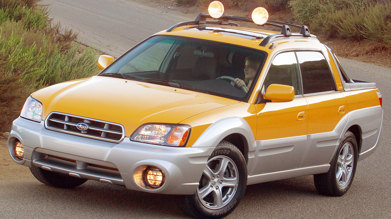 Front 3/4 view of a yellow Subaru Baja with silver cladding