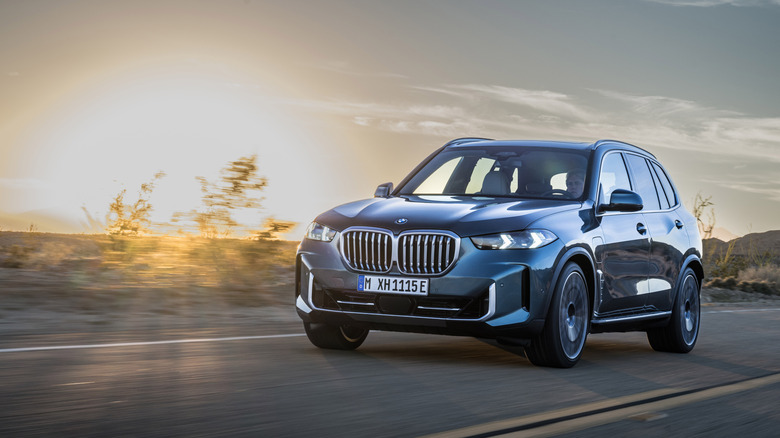 A blue 20204 BMW X5 on a desert roadway.