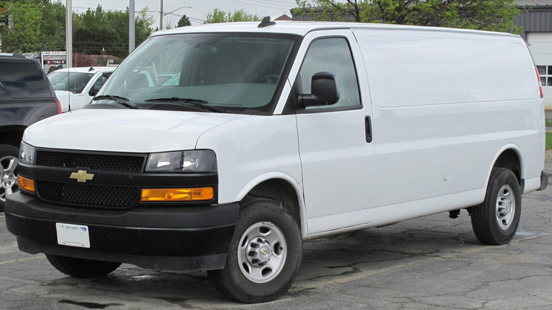 A front 3/4 view of a white 2021 Chevrolet Express van