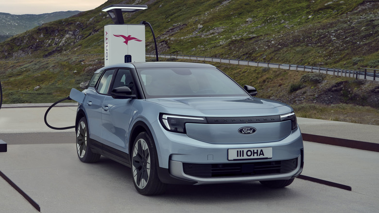 A 2025 Ford Explorer plugged into a charging port