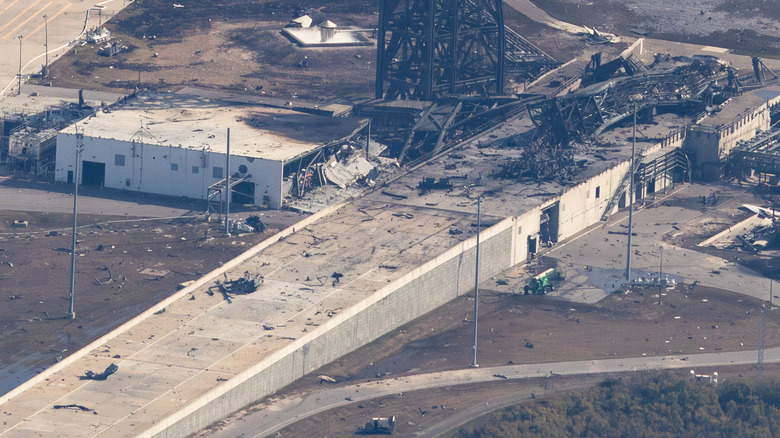 Aerial view of the destroyed Transporter Erector and a nearby building at Launch Complex 36