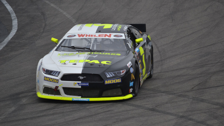 A white and black Ford Mustang stock car in the NASCAR Euro series.