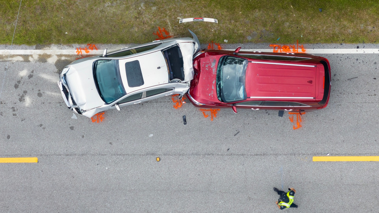 Crashed cars aft postulation mishap parked connected road roadside.