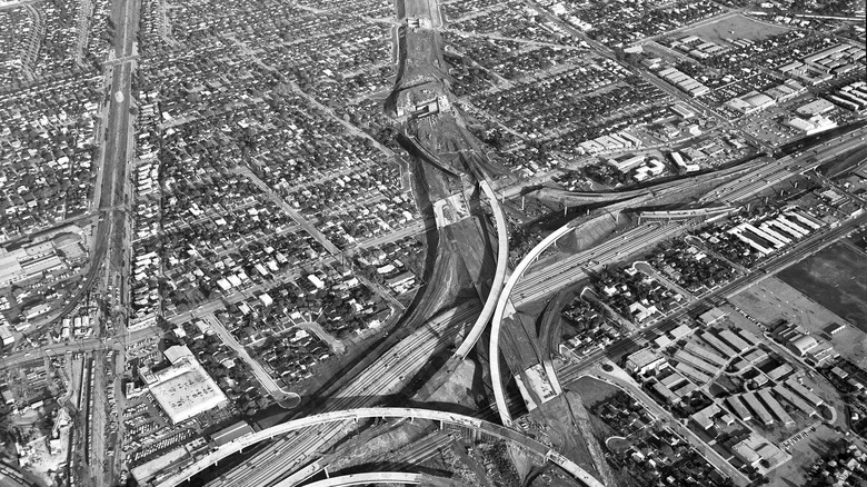 Aerial view of construction of Santa Monica Freeway (I-10, running vertically) at San Diego Freeway (I-405) interchange in Los Angeles, facing east.