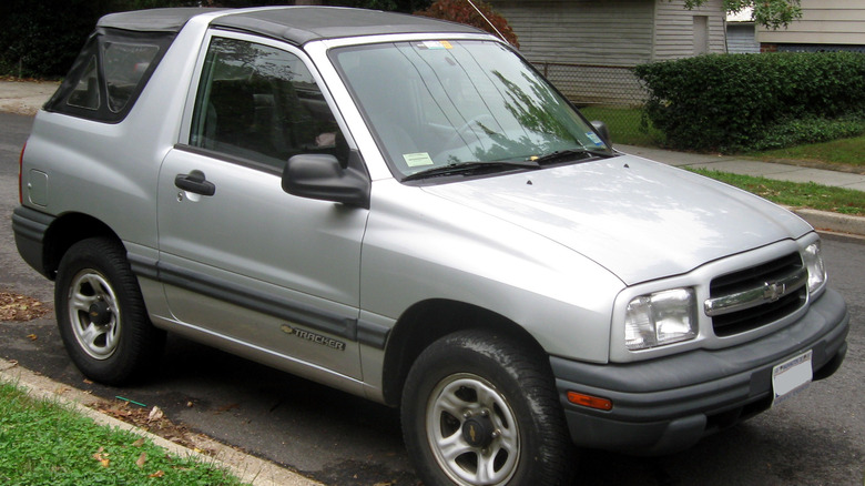 A front-quarter view of a silver Chevrolet Tracker parked on a residential street