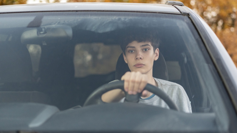 Close-up shot of a teenager driving