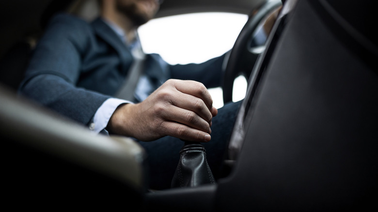 Man operating manual gearbox.