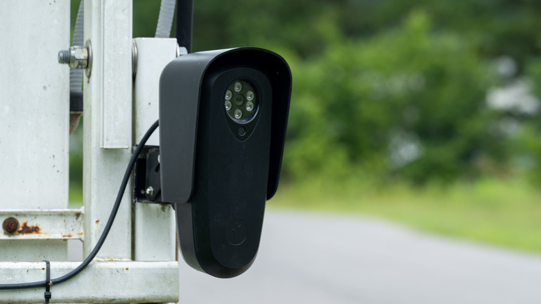A close up of a Flock camera next to a road