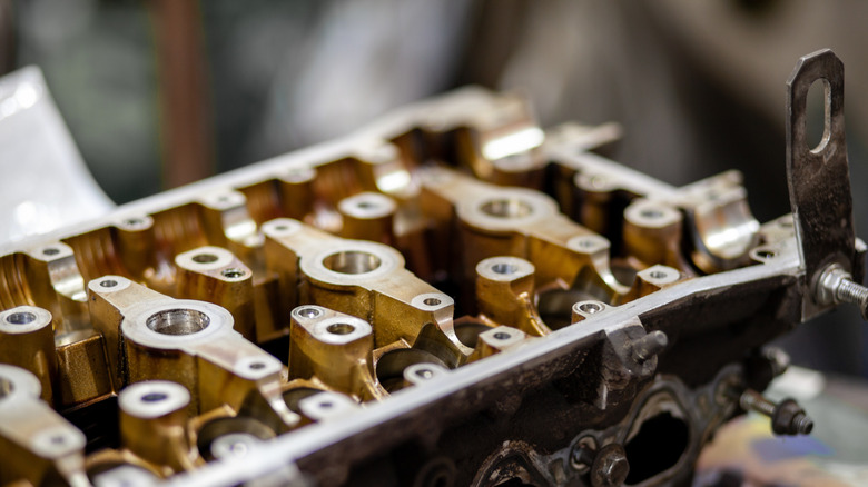 Detailed view of a cylinder head showcasing its components, in automotive mechanics in a workshop.