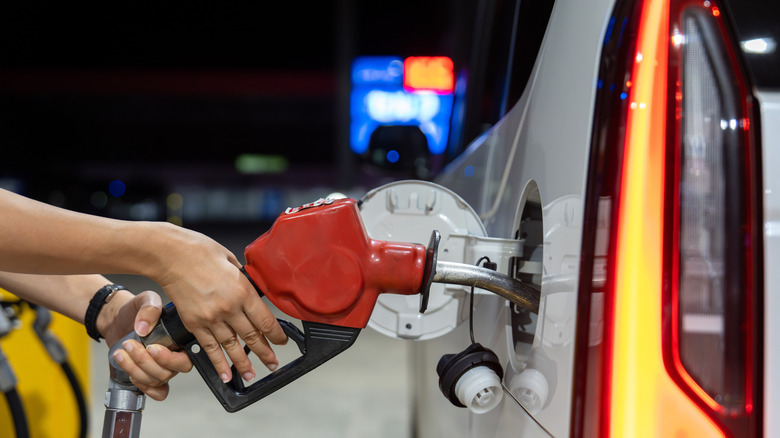 A person fueling up at a gas station.