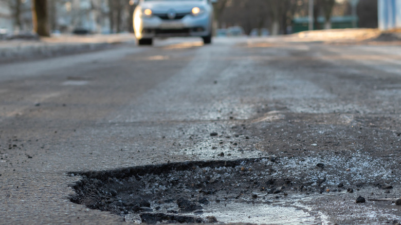 A pothole on an icy road.