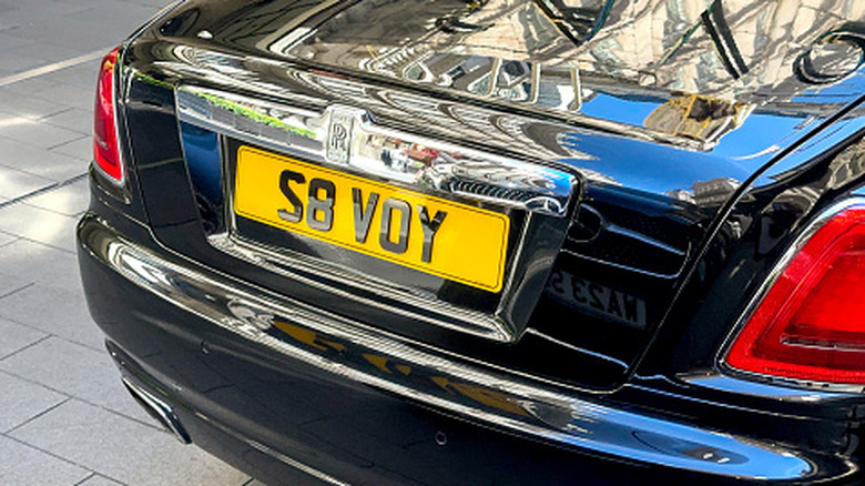 Black Rolls-Royce with a UK personalized license plate