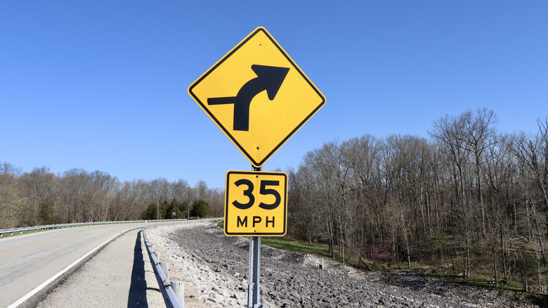 An example of an advisory speed plaque on a highway warning sign