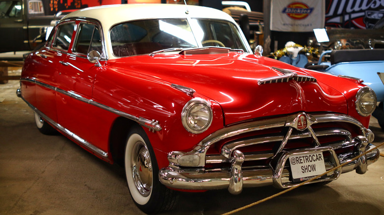 A red Hudson Hornet with a two-pane windshield
