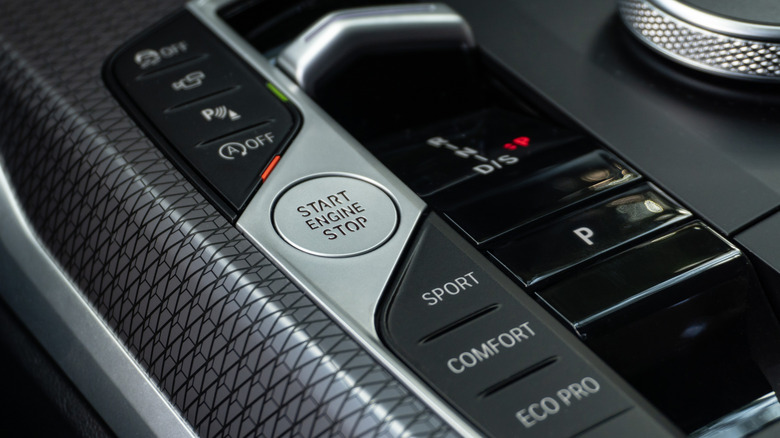 BMW's auto stop-start function, next to the main ignition button in the center console.