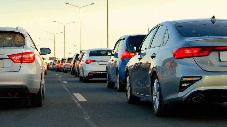 Cars in traffic on a main road on a sunny evening