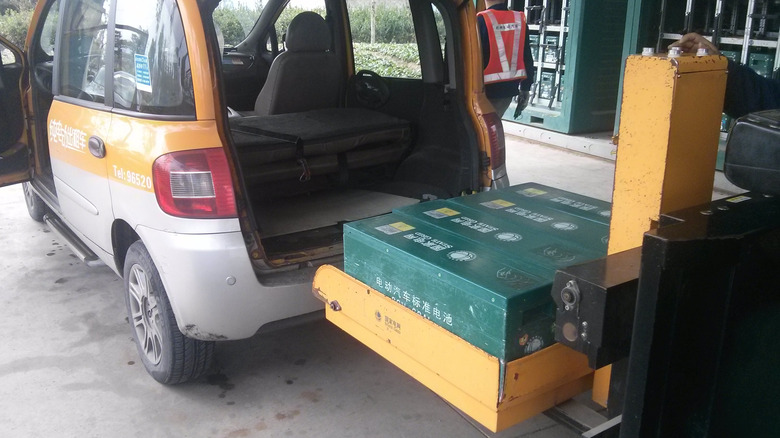 A small hatchback's battery being swapped
