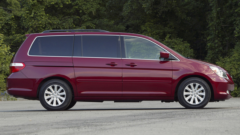 Side profile of a 2005 Honda Odyssey Touring in red.