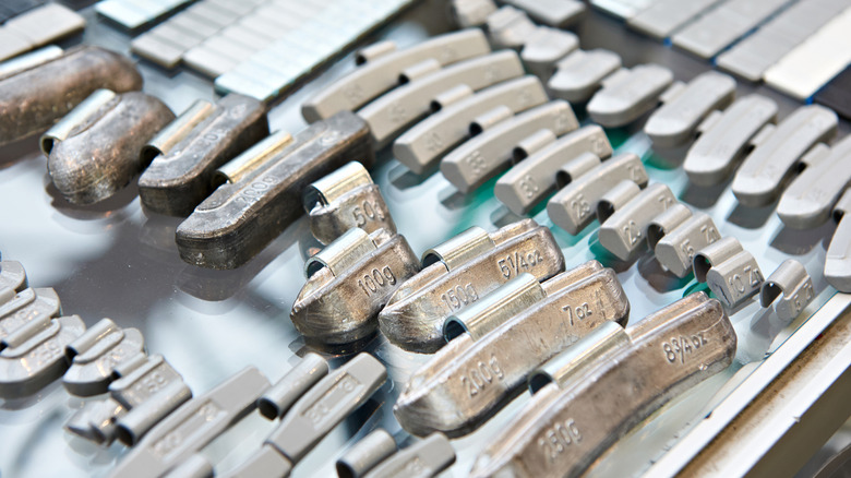 A selection of wheel weights used in balancing wheels during tire installation.