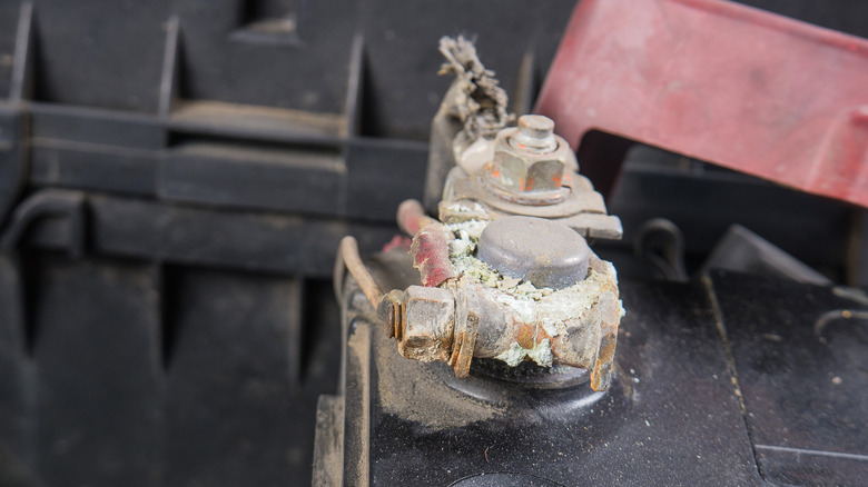 Visible corrosion on car battery terminals