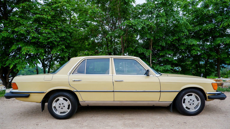 A tan 1974 Mercedes-Benz W116 sedan
