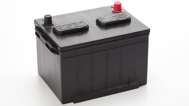 A standard 12-volt car battery against a white background.