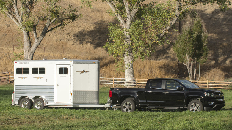A 2.8-liter Duramax Chevrolet Colorado pulling a horse trailer in a field