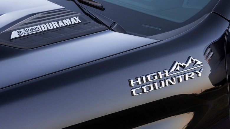 a close up image of a chevy silverado with duramax diesel engine badges