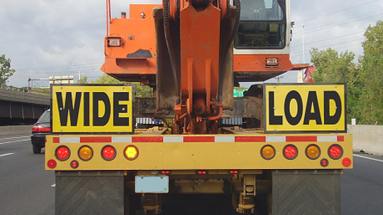 A semi hauling construction equipment classified as a wide load