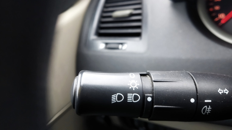 A closeup of a headlight toggle on the turn signal stock of a vehicle