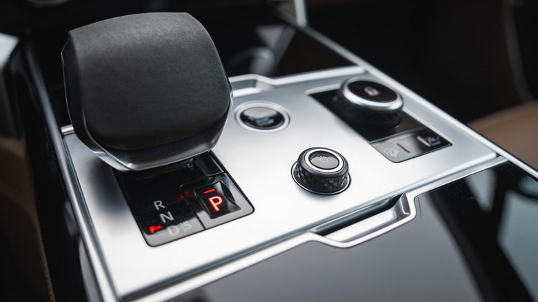 A close-up of the center console of a vehicle with piano black trim.