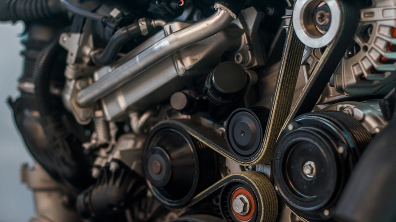 A close-up of an engine showing a serpentine belt
