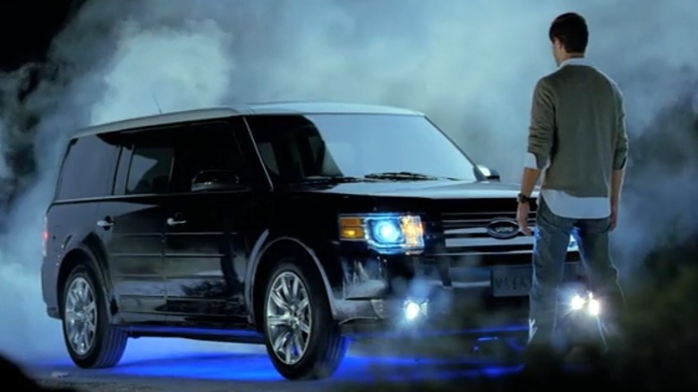 A still from a Ford Flex ad for the middle east in 2008 showing a man standing in front of the vehicle surrounded by smoke