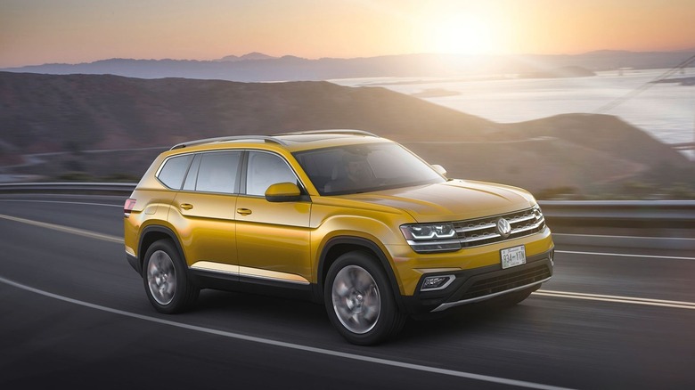 A Volkswagen Atlas in yellow driving near the coast
