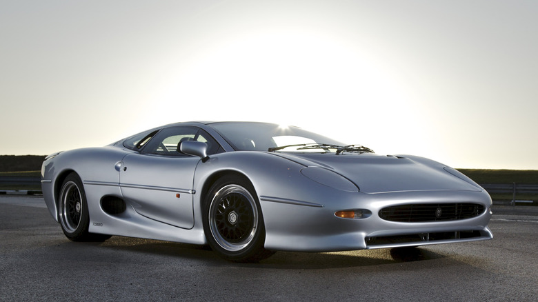 A silver Jaguar XJ220 parked in the sunlight