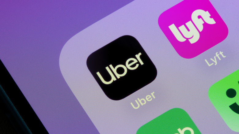 A smartphone app displays rideshare icons for Uber and Lyft
