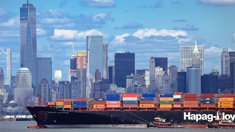 A large Hapag-Lloyd cargo vessel pinch New York City arsenic background