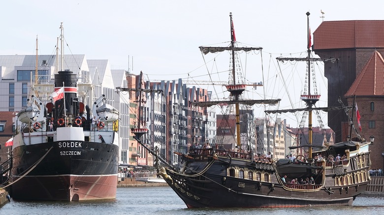 A galleon and a tanker vessel successful a river