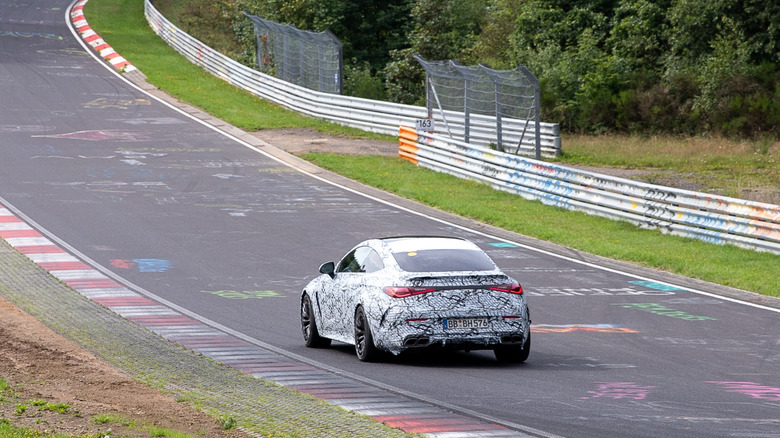 A camouflaged Mercedes-Benz undergoing development testing at the Nürburgring.