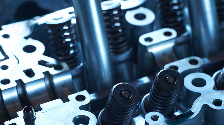 Closeup of a disassembled engine. The upper part with valves and springs.