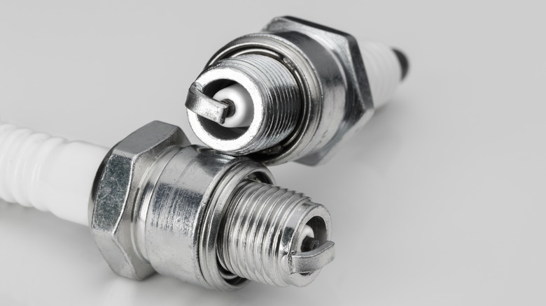 A pair of new spark plugs for two-stroke motorcycle engines.