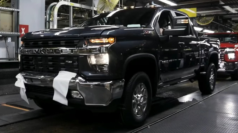 A black Chevrolet Silverado on an assembly line