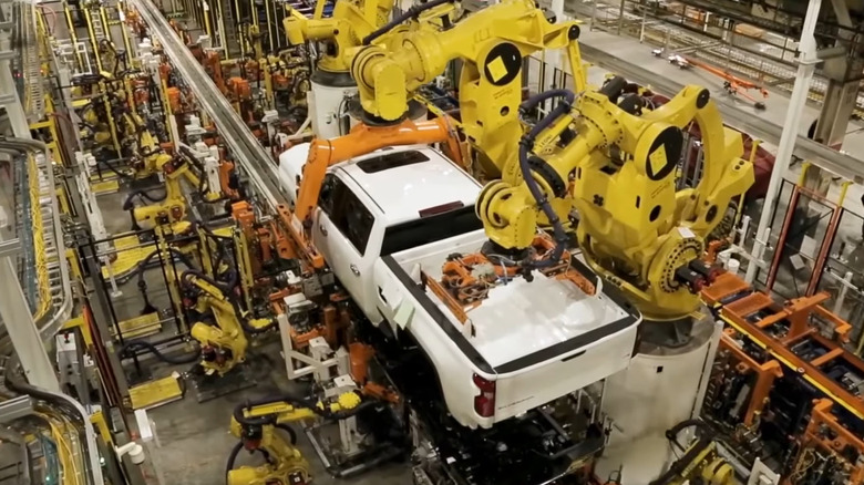 A white Chevrolet Silverado being assembled