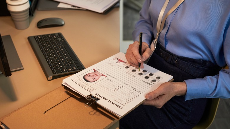 Woman holding criminal record