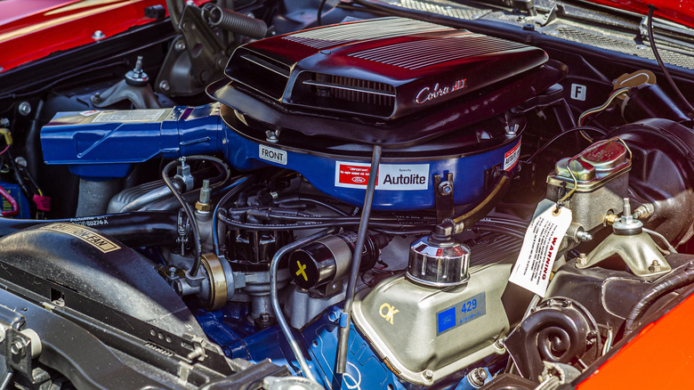 A blue Ford 429 Super Cobra Jet with ram air in a red 1970 Ford Torino