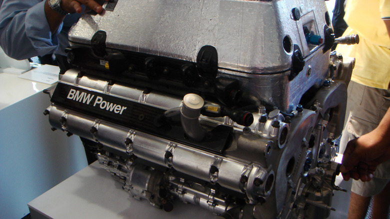 The BMW P86 Formula 1 V8 on a workbench being inspected