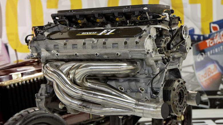 A Renault Formula 1 V10 sits on a stand in a museum