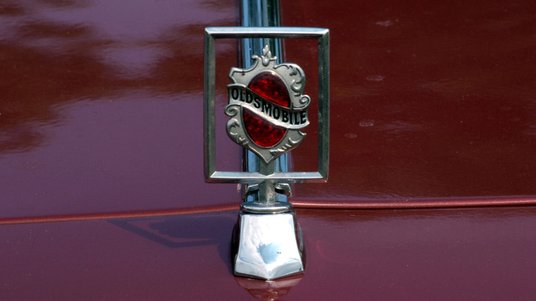 The hood ornament of an Oldsmobile Royal 88 painted red
